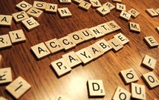 An scrabble featuring the text accounts payable